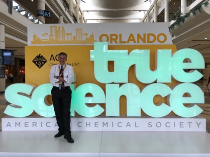 Rigoberto Hernandez in front of the “I” of a True Science scultpure.