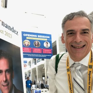 Hernandez standing next to his billboard at the ACS Meeting in Chicago